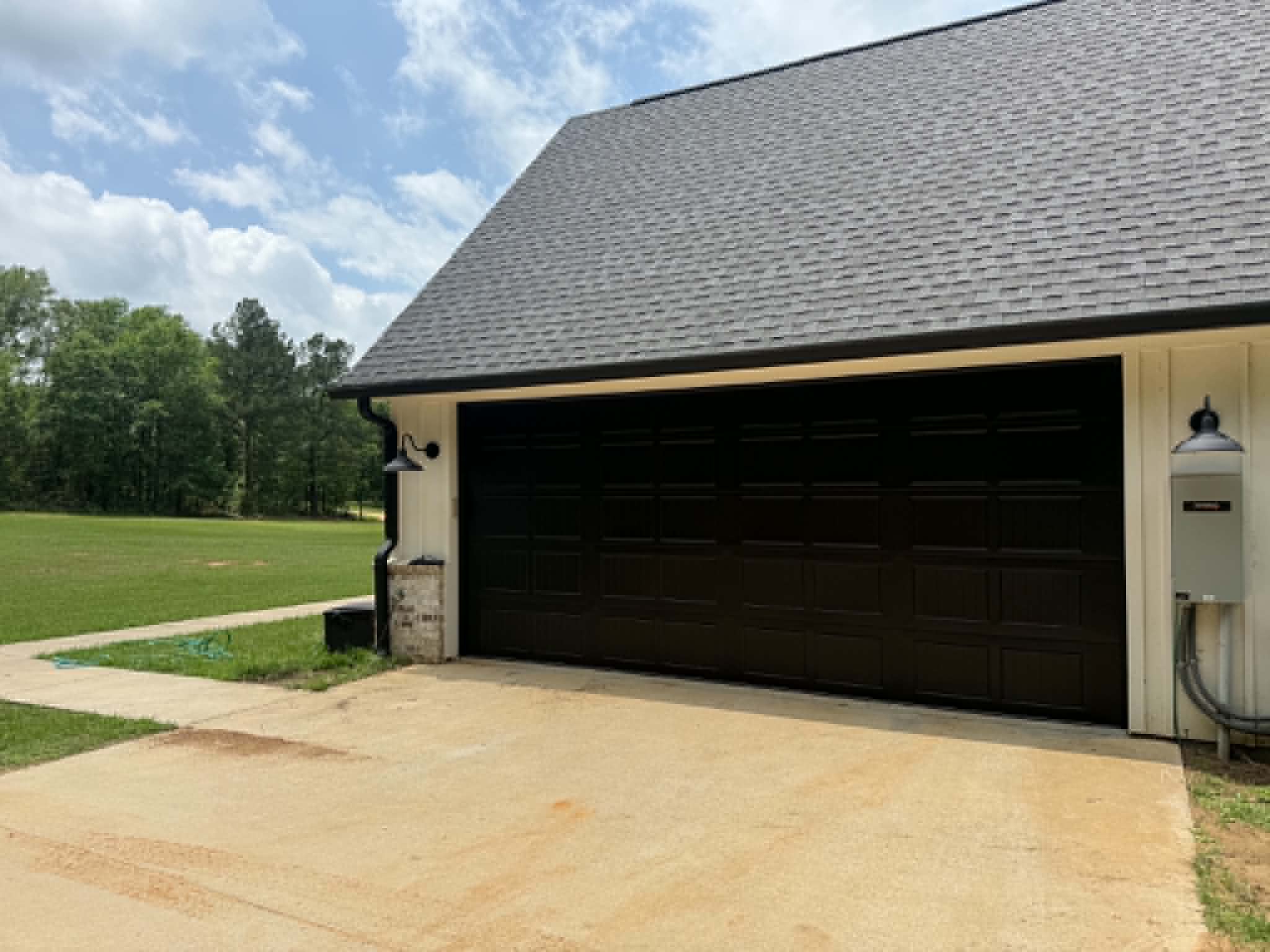 A new black garage door on a country home outside Tyler, Texas
